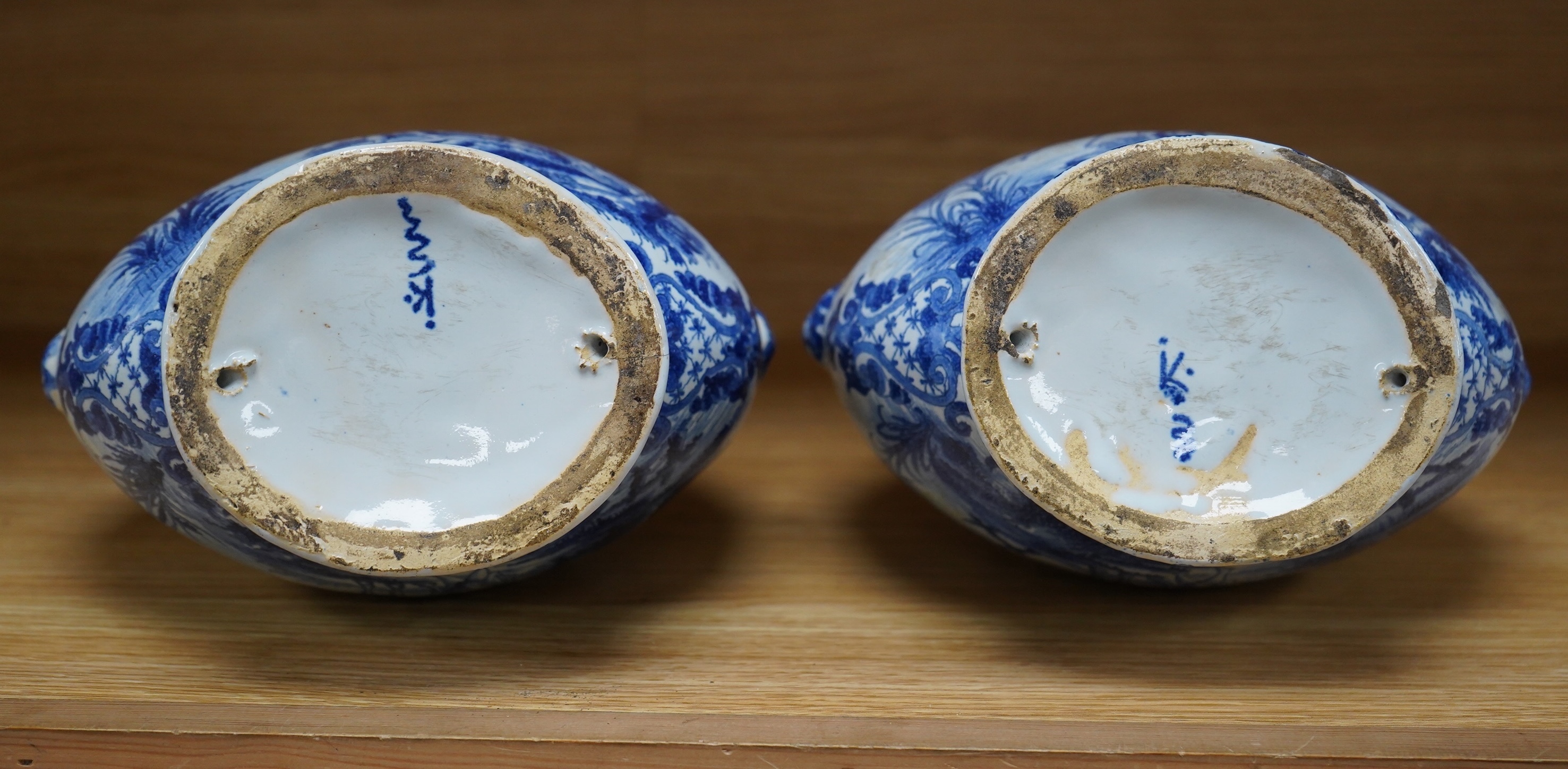 A pair of mid 18th century Delft blue and white flagons